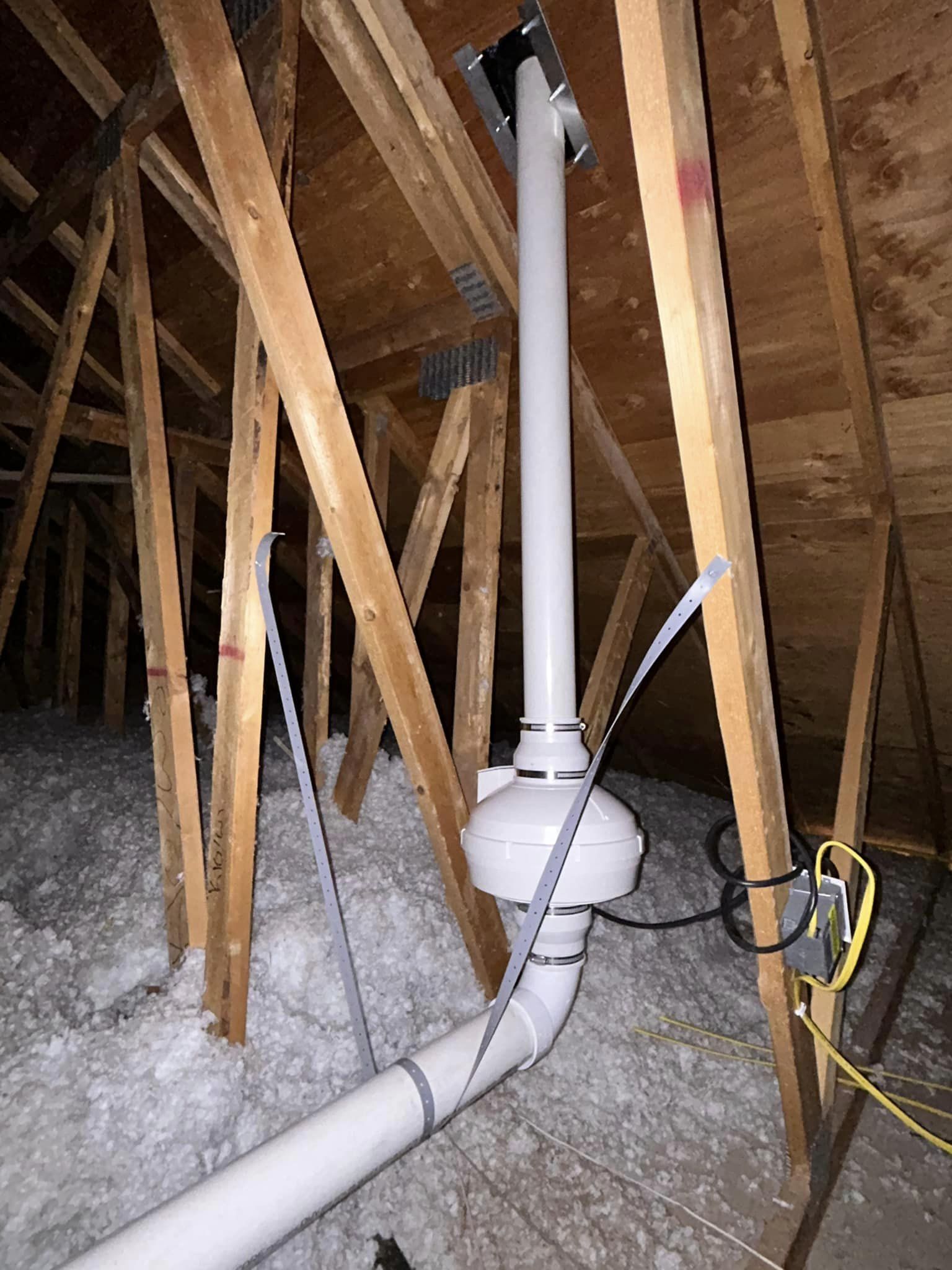 Vertical radon fan and connected piping in an attic