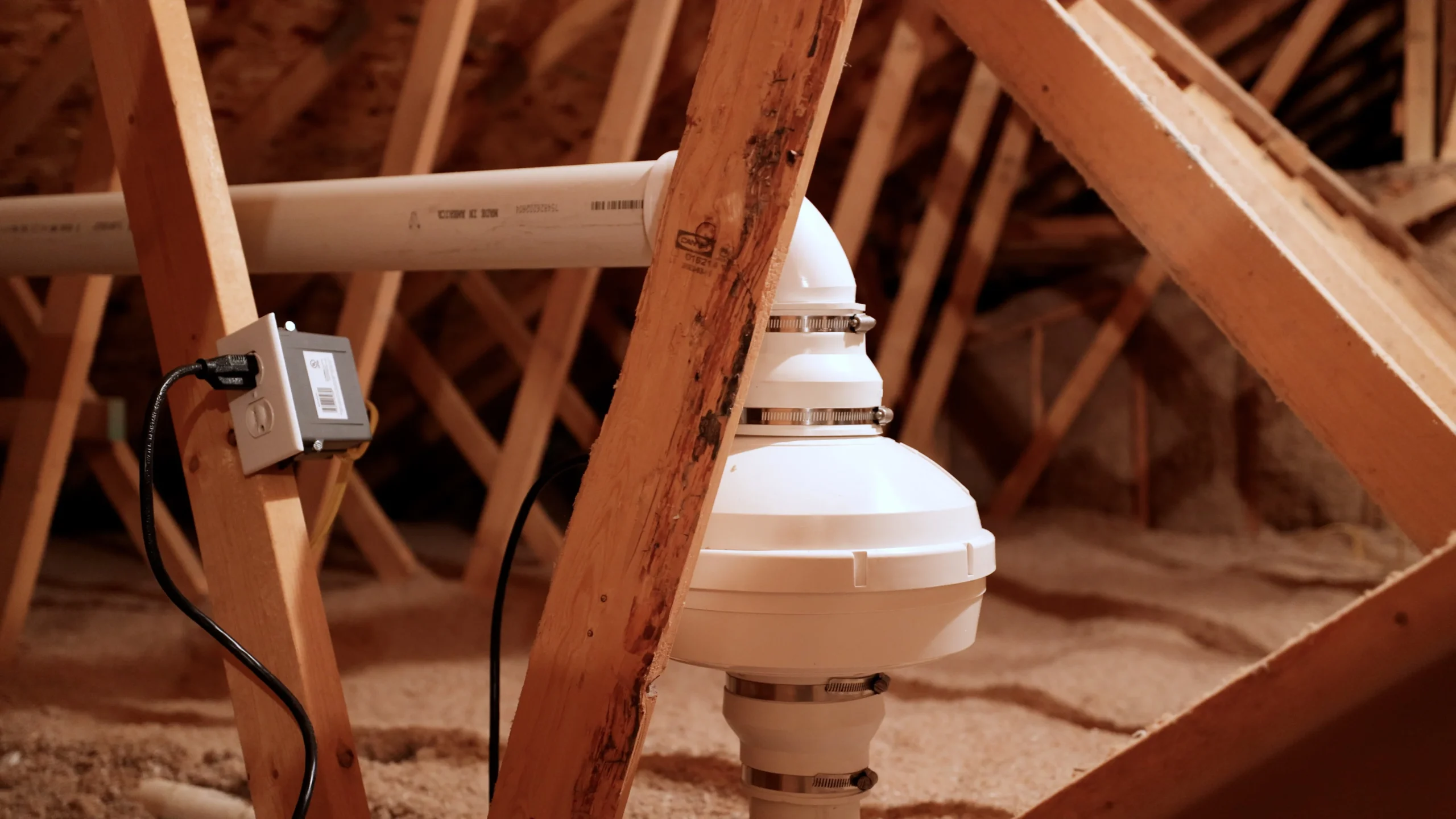 Inline radon fan connected to attic vent piping
