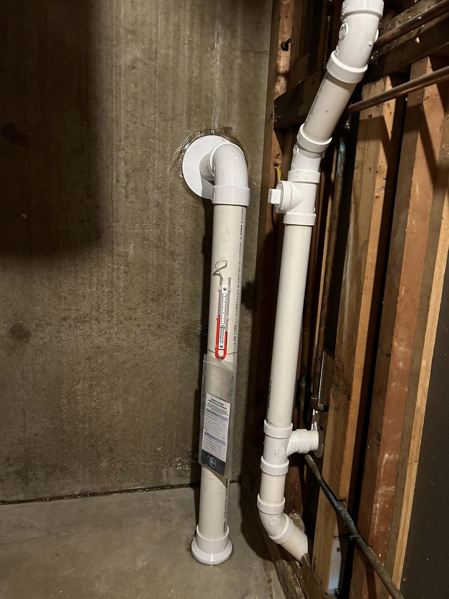 U-tube pressure indicator attached to basement radon piping