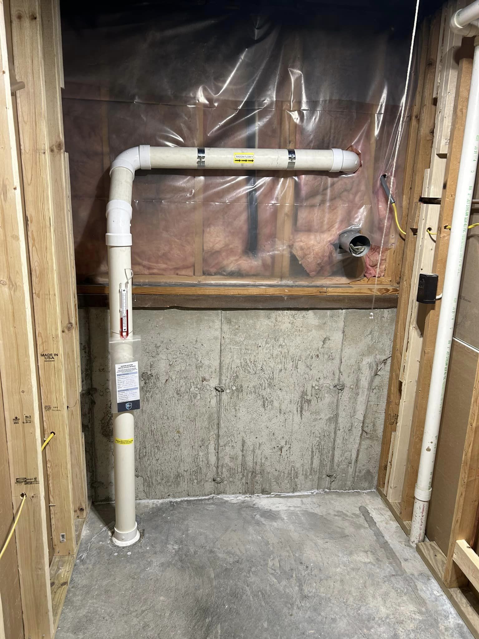 Radon pipe and pressure indicator in a basement installation