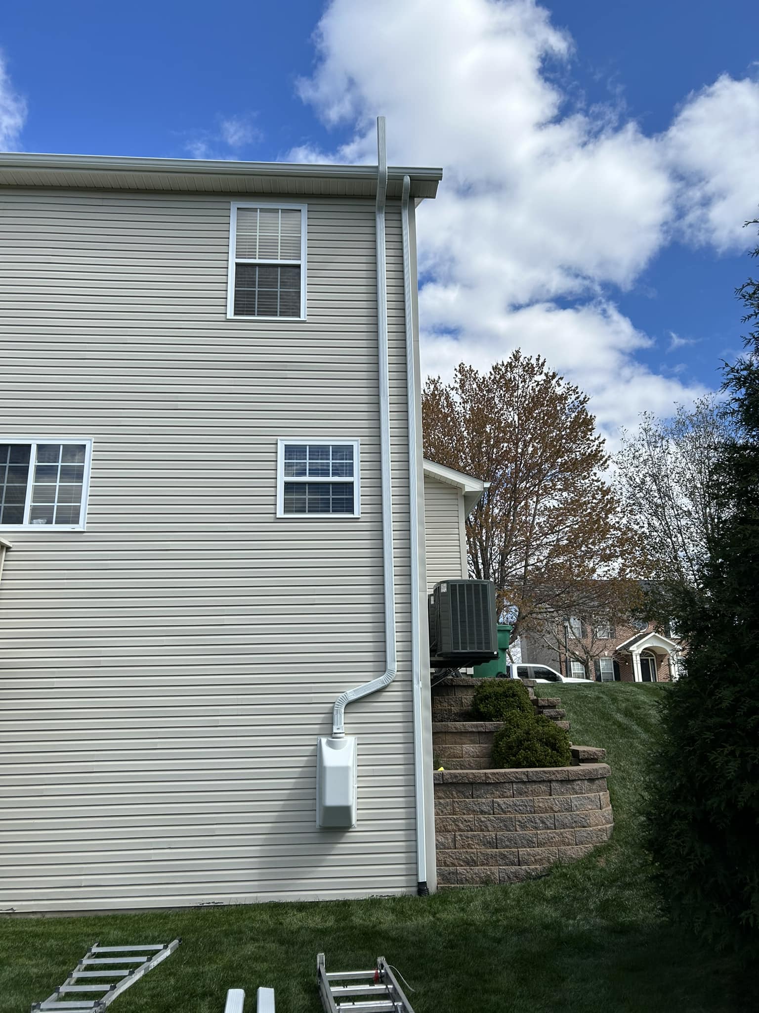 Exterior radon vent piping beside home siding